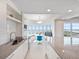 Bright kitchen with white cabinets, stone countertops, and a breakfast nook overlooking the ocean at 2 Oceans West Blvd # 2006, Daytona Beach Shores, FL 32118
