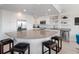 Modern white kitchen with a large center island and stainless steel appliances at 2 Oceans West Blvd # 2006, Daytona Beach Shores, FL 32118