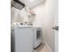 Bright laundry room with new washer and dryer and white cabinets at 2 Oceans West Blvd # 2006, Daytona Beach Shores, FL 32118