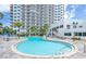 Community features an outdoor pool, spa, and seating area, surrounded by lush landscaping at 2 Oceans West Blvd # 2006, Daytona Beach Shores, FL 32118