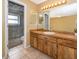 Bathroom with a light wood vanity and a sliding glass door shower/toilet room at 201 Twelve League Cir, Casselberry, FL 32707