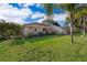 Exterior side view of a home with a well-kept lawn and mature landscaping at 201 Twelve League Cir, Casselberry, FL 32707