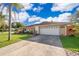 Exterior view of a well-maintained home with a two-car garage and a long driveway at 201 Twelve League Cir, Casselberry, FL 32707