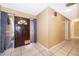 A foyer with tile flooring, neutral wall paint, and a view of the front door at 201 Twelve League Cir, Casselberry, FL 32707