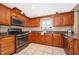 Close up of an updated kitchen with stainless steel appliances, granite countertops, and tile backsplash at 201 Twelve League Cir, Casselberry, FL 32707