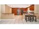 Spacious kitchen featuring custom wood cabinets, stainless steel appliances, granite countertops, and a breakfast bar at 201 Twelve League Cir, Casselberry, FL 32707
