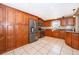 Well-equipped kitchen with wood cabinets, stainless steel appliances, granite countertops, and tile flooring at 201 Twelve League Cir, Casselberry, FL 32707