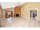 Open living room with vaulted ceilings, stone fireplace, tile floors, and sliding glass doors to the sunroom at 201 Twelve League Cir, Casselberry, FL 32707