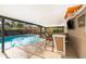 Enclosed pool area featuring a bar, inground pool, and a jacuzzi tub at 201 Twelve League Cir, Casselberry, FL 32707