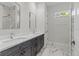 Bright bathroom with double vanity, marble countertops, and modern sinks and fixtures at 20446 Quinlan St, Orlando, FL 32833