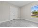 Spacious bedroom with double door closet, big window, and light gray floors at 20446 Quinlan St, Orlando, FL 32833