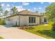 Modern home with a two-car garage, concrete driveway and well-manicured lawn at 20446 Quinlan St, Orlando, FL 32833