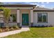 Striking turquoise front door framed by elegant columns and lush landscaping at 20446 Quinlan St, Orlando, FL 32833