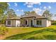 Charming single-story home with a well-manicured lawn and a striking turquoise front door at 20446 Quinlan St, Orlando, FL 32833