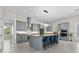 Modern kitchen with stainless steel appliances, a large island with bar seating, and custom cabinets at 20446 Quinlan St, Orlando, FL 32833
