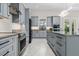 Stylish kitchen featuring gray cabinets, granite countertops and modern stainless steel appliances at 20446 Quinlan St, Orlando, FL 32833