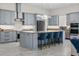 Stylish kitchen with stainless steel appliances, a spacious island, and blue barstools at 20446 Quinlan St, Orlando, FL 32833