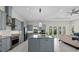 Modern kitchen with gray cabinets, stainless steel appliances, and large center island at 20446 Quinlan St, Orlando, FL 32833
