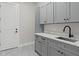 Functional laundry room with modern cabinets, ample counter space, and stylish gray color scheme at 20446 Quinlan St, Orlando, FL 32833