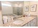 Bathroom with double sinks, granite countertops, and a tiled shower and tub at 2123 Lelani Cir, Davenport, FL 33897
