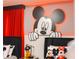 Stylish bedroom boasts custom Mickey Mouse decor, including a large wall mural and plush toys at 2123 Lelani Cir, Davenport, FL 33897