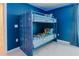 Fun bedroom features a custom-made bunk bed designed with a cargo container theme at 2123 Lelani Cir, Davenport, FL 33897