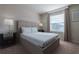 Cozy bedroom offering a comfortable bed, sleek bedside tables, and soft window lighting at 2123 Lelani Cir, Davenport, FL 33897