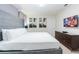 Comfortable bedroom with art, neutral tones, and a large television for entertainment and relaxation at 2123 Lelani Cir, Davenport, FL 33897