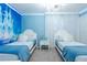 Charming bedroom features twin beds, a chandelier, and a Disney 