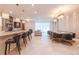 Open concept dining and living area featuring modern chandeliers, dining table with chairs, and large windows at 2123 Lelani Cir, Davenport, FL 33897