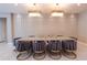 Dining room showcasing modern chairs and gold accents, with unique lighting fixtures at 2123 Lelani Cir, Davenport, FL 33897