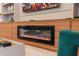 Modern linear fireplace with shelving, a flat screen television, and seating for entertaining at 2123 Lelani Cir, Davenport, FL 33897