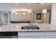 Open kitchen with large granite island, stainless steel appliances, and elegant pendant lighting at 2123 Lelani Cir, Davenport, FL 33897