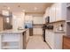 Bright kitchen featuring white cabinets, stainless steel appliances, and an island with a sink at 2123 Lelani Cir, Davenport, FL 33897