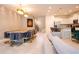 Open concept living room with modern furnishings, designer lighting, adjacent to dining area, and kitchen at 2123 Lelani Cir, Davenport, FL 33897