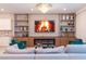 Open living room with custom built-ins, fireplace, comfortable seating, and modern lighting at 2123 Lelani Cir, Davenport, FL 33897