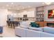 Open-concept living room featuring a modern kitchen, fireplace, and comfortable seating at 2123 Lelani Cir, Davenport, FL 33897