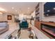 Open-concept living space features modern decor, fireplace, and seamless flow to the kitchen at 2123 Lelani Cir, Davenport, FL 33897