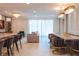 Open-concept living and dining area with stylish chandeliers and modern furnishings at 2123 Lelani Cir, Davenport, FL 33897
