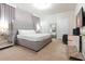 Stylishly furnished bedroom features neutral tones, sleek furniture, ensuite, and abundant natural light at 2123 Lelani Cir, Davenport, FL 33897