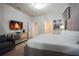 Comfortable bedroom with a large bed, accent chair, stylish dresser, and TV, creating a cozy retreat at 2123 Lelani Cir, Davenport, FL 33897