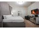 Main bedroom features a large bed, dresser with TV, and access to a mirror at 2123 Lelani Cir, Davenport, FL 33897
