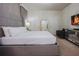 Comfortable bedroom with a large bed, accent chair, stylish dresser, and TV, creating a cozy retreat at 2123 Lelani Cir, Davenport, FL 33897