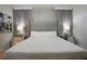 Main bedroom features a large headboard, stylish bedside lamps, and elegant decor at 2123 Lelani Cir, Davenport, FL 33897
