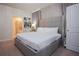 Serene bedroom featuring a large bed, ensuite bathroom access, and modern decor at 2123 Lelani Cir, Davenport, FL 33897