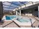 Enclosed pool and spa with patio and dining set at 2123 Lelani Cir, Davenport, FL 33897