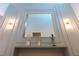 Modern wall decor showcasing bright lighting fixtures, a mirror, and decorative vases at 2123 Lelani Cir, Davenport, FL 33897