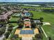 Expansive aerial view highlighting community amenities, including a pool, tennis court, and bocce ball court at 223 Silver Maple Rd, Groveland, FL 34736
