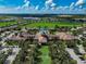 Aerial view of a luxurious community clubhouse with a pool, surrounded by lush green spaces and homes at 223 Silver Maple Rd, Groveland, FL 34736
