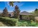 Exterior backyard view with screened-in lanai surrounded by lush landscaping and well-kept green grass at 223 Silver Maple Rd, Groveland, FL 34736